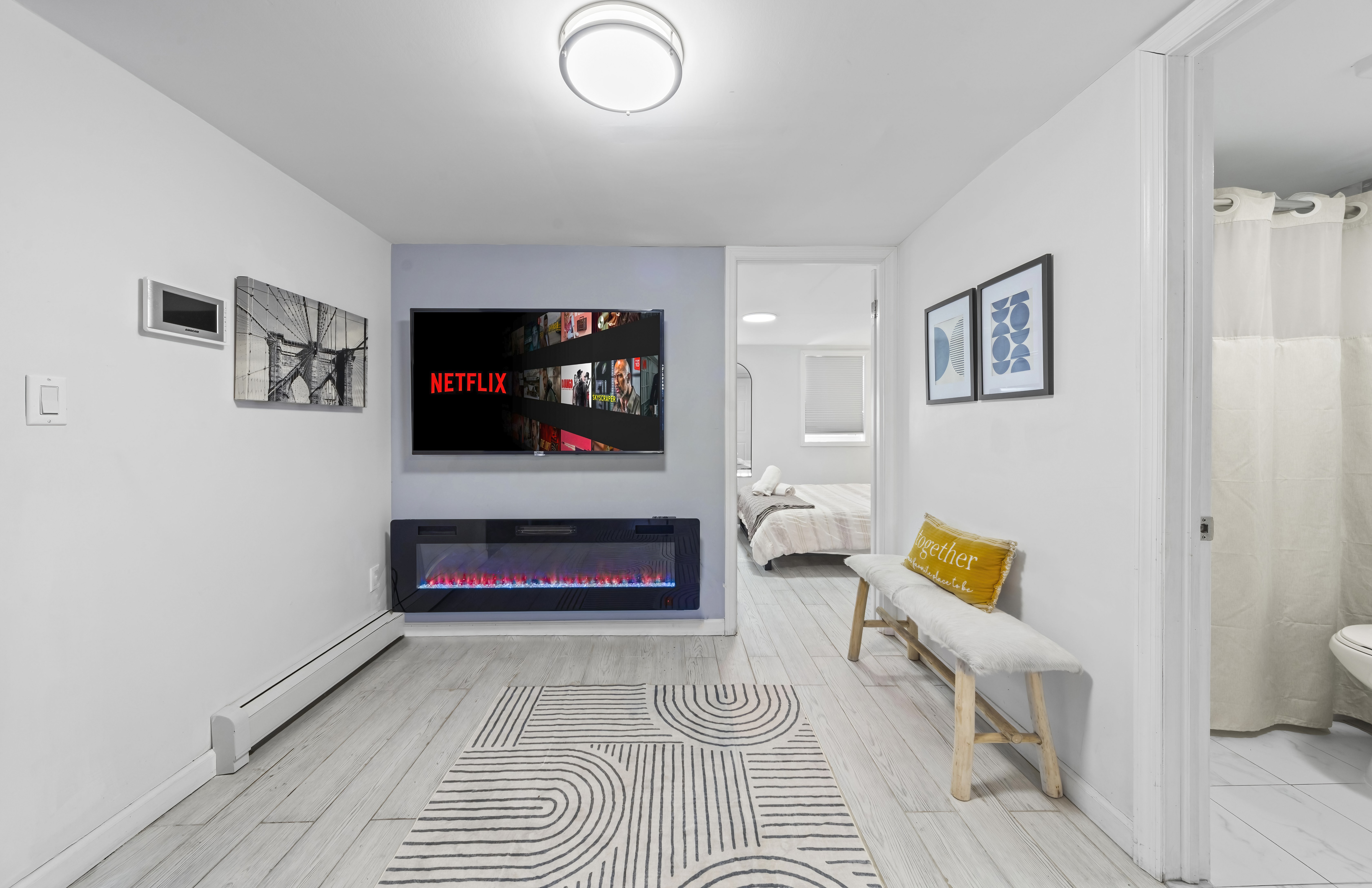 Living room with wall-mounted TV and LED fireplace